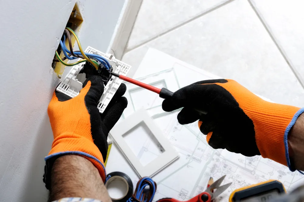 Electrician wiring a new socket during a house rewire