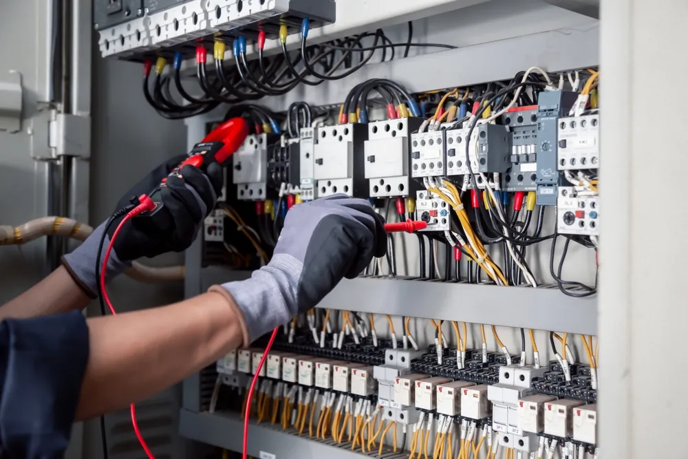 Electrician in Falmouth testing a distribution board