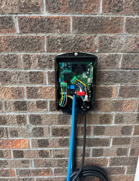 EV charger wiring during installation on a brick wall