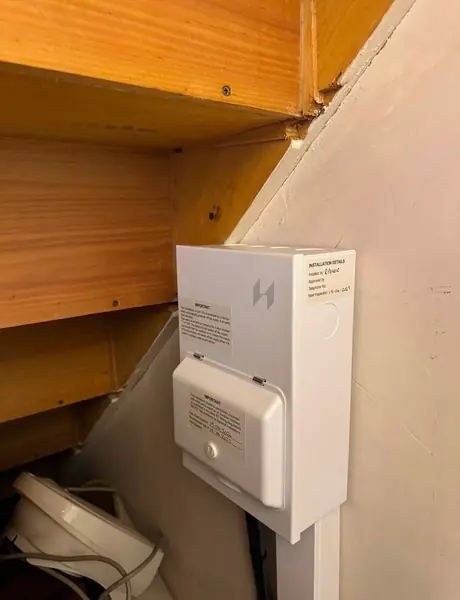 Wall-mounted electrical unit installed beneath a staircase